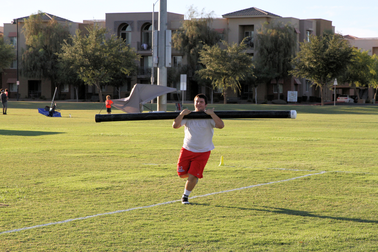 Football player carrying a pole